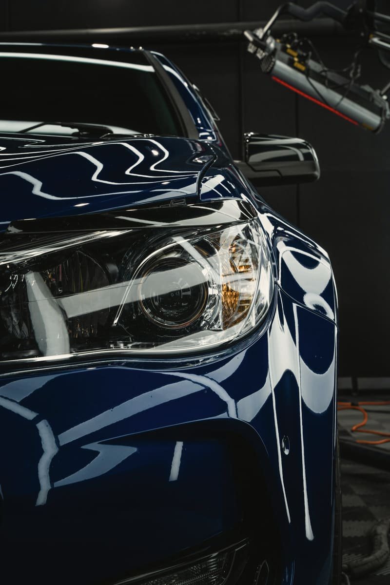 Hard specular highlights running across glossy dark blue paint