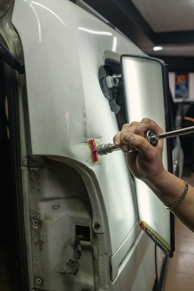 Stud puller drawing a dent out of a door skin